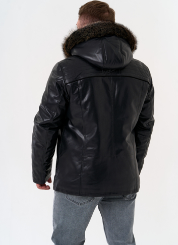 Пуховик из эко кожи с капюшоном из меха енота